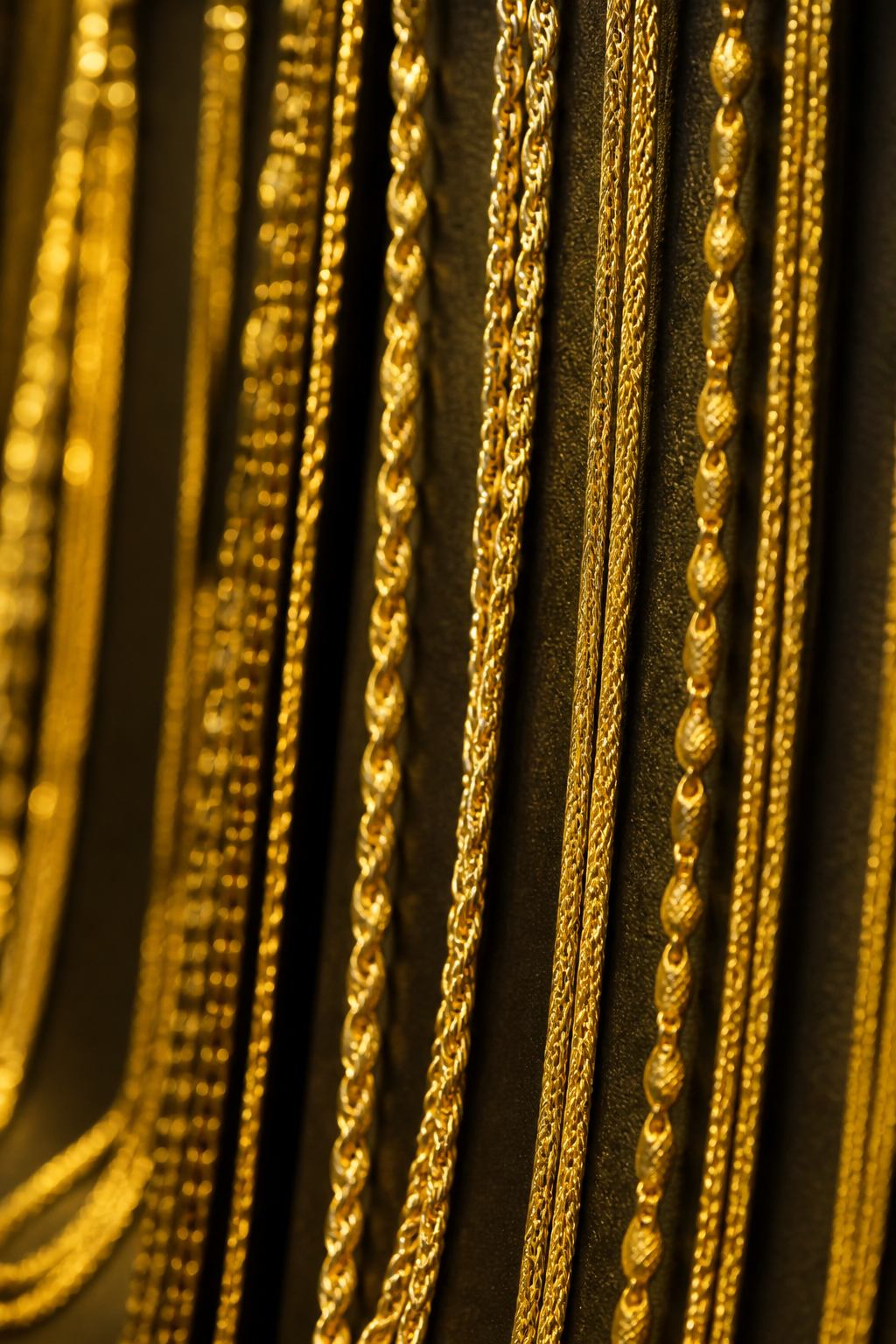 22K gold chains and necklaces hanging in the showcase at Aryam's Jewelry, gold store in Houston